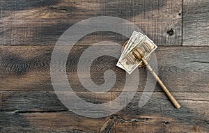 Judges gavel with soundboard and US dollar banknotes