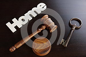 Judges Hammer or Gavel With Home Sign On Dark Background