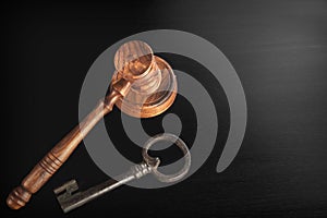 Judges Hammer or Gavel With Old Key On Dark Background