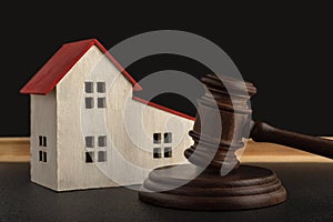 Judges hammer and model of house. Confiscated housing. Resolving property disputes