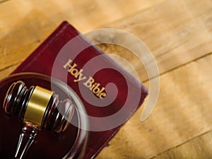 Judgment and Justice. Judge`s gavel on the book of the Holy Bible on a wooden background. Low angle view. There are no people in