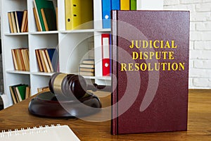 Judicial dispute resolution book on the desk.