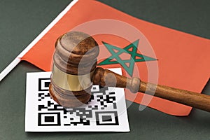 Judicial gavel, barcode sheet and Moroccan flag, the concept of administrative punishment for violating the regime using QR codes