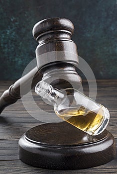 Judicial gavel and a bottle of alcohol