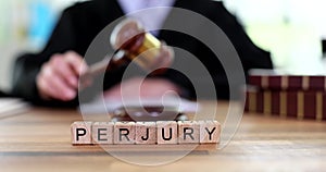 Judicial gavel of justice with text of perjury at judge