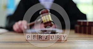 Judicial gavel of justice with text of perjury of judge in courtroom