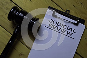 Judicial Review Document form and Black Judges gavel on wooden desk. Law concept