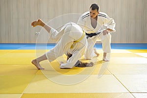 Judo master and young judo girl are training