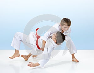 In judogi boys are training judo throws