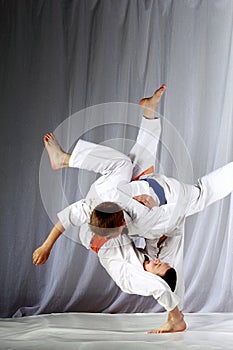 In judogi two athletes doing judo throws