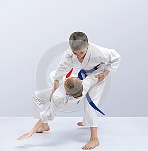 In judogi boys are training throws