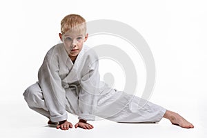 Judoka boy doing stretching at workout