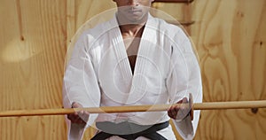 Judoka holding a wooden saber