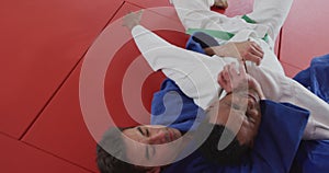 Judoka strangling his opponent on the judo mat