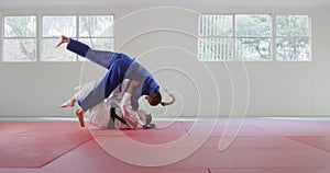 Judokas fighting and immobilizing on the ground