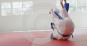 Judokas fighting and immobilizing on the ground