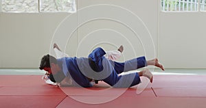 Judokas fighting and immobilizing on the ground