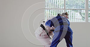 Judokas training by doing a randori on the judo mat