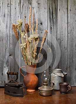 Jug with dry reeds and old things