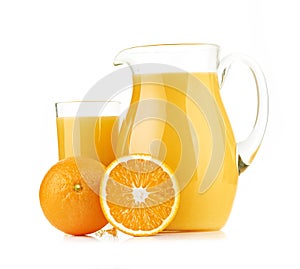 Jug, glass of orange juice and orange fruits