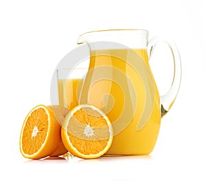 Jug, glass of orange juice and orange fruits