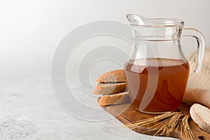 Jug with kvass on a white background. A traditional Russian soft drink with rye bread