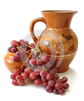 Jug and red grapes