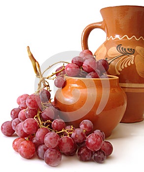 Jug and red grapes