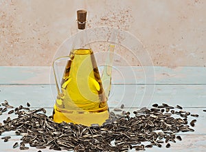 A jug of sunflower oil on blue wooden background