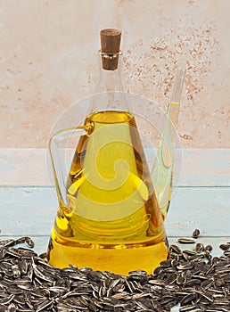 A jug of sunflower oil on blue wooden background