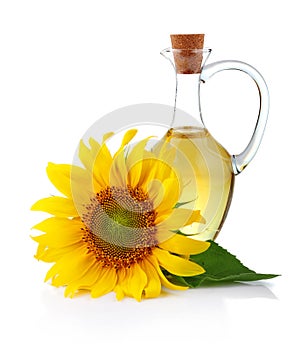 Jug sunflower oil with flower isolated on white