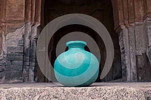 A jug of water in the arch of the old temple.  Take a sip on a hot day