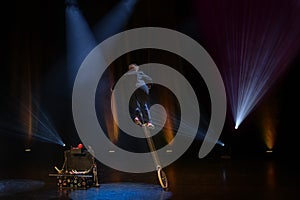 Juggler clown in the circus arena on unicycle