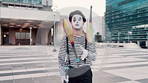 Juggling, mime and man in city for circus, entertainment and creative act in urban town. Street performer, theatre and