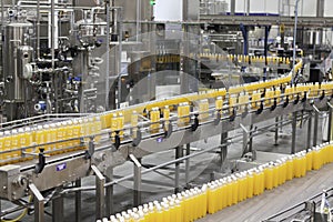 Juice bottles moving along the conveyor belt