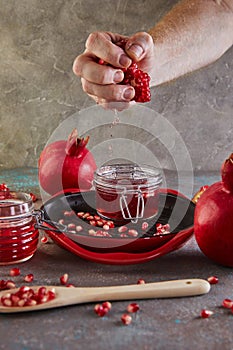 Juice flowing into a jar of pomegranate syrup from home-made pomegranate syrup