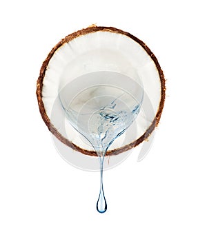 Juice flows from a slice of coconut on a white background