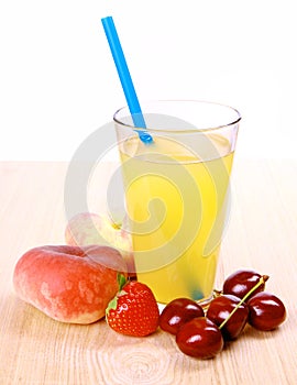 Juice in glass with platt peach, cherries, strawberry