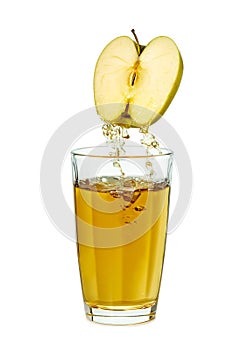 Juice poring from apple half to glass on white background