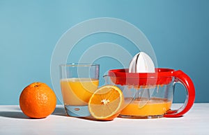 Juicer with glass of fresh squeezed orange juice