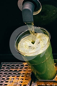 Juicer machine making green smoothie