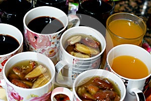 Juices, drinks and compotes tray on the iftar table in Ramadan month with dates, dried fruits figs, apricot, raisins compote photo