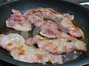 Juicy bacon rasher in hot oil