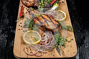 Juicy barbecue pork ribs beer, snacks lie on a wooden tray.