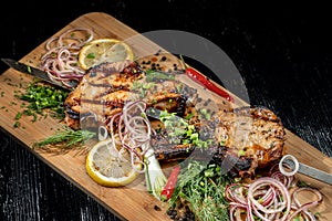 Juicy barbecue pork ribs beer, snacks lie on a wooden tray.