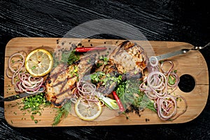 Juicy barbecue pork ribs beer, snacks lie on a wooden tray.