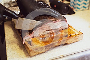 Juicy beef brisket on chopping block photo