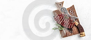 Juicy Beef rump steak from marble beef medium rare served on old meat butcher on cutting board light background, Long banner