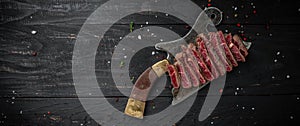 Juicy Beef rump steak from marble beef medium rare served on old meat butcher on dark wooden background. Long banner format, top