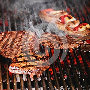 Juicy beef steak flips in a barbecue flame, life style, food photo, copy space